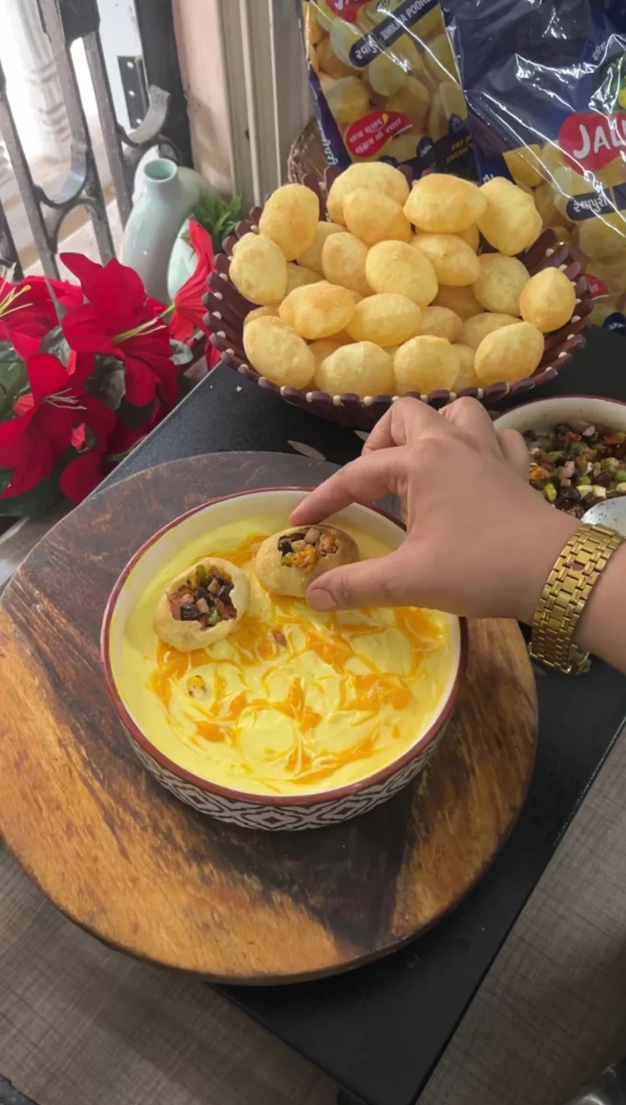 Assemble the Dahi Puri: Fill the puris with the prepared filling. Top with the mango curd and Mexican spices.