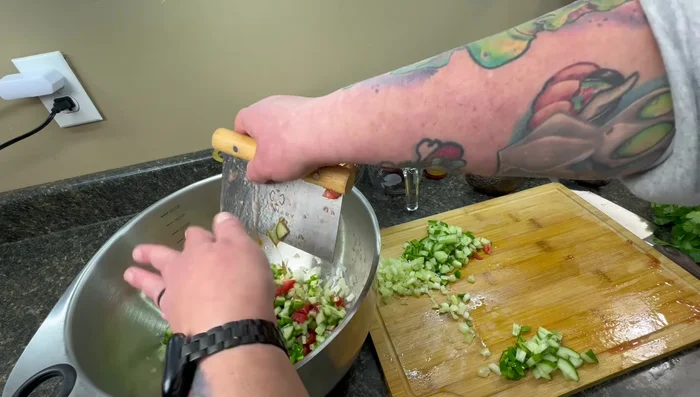 Combine all chopped produce (celery, onion, jalapeno, cucumber, tomato) in a bowl with the lime juice and onion.