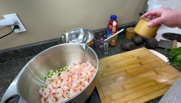 Add precooked shrimp, salt, and pepper to the bowl. Taste and adjust seasonings.