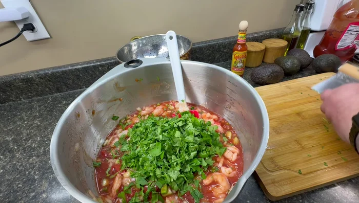 Add cilantro (or parsley) and hot sauce. Taste and adjust hot sauce as needed. The mixture will get spicier as it sits.