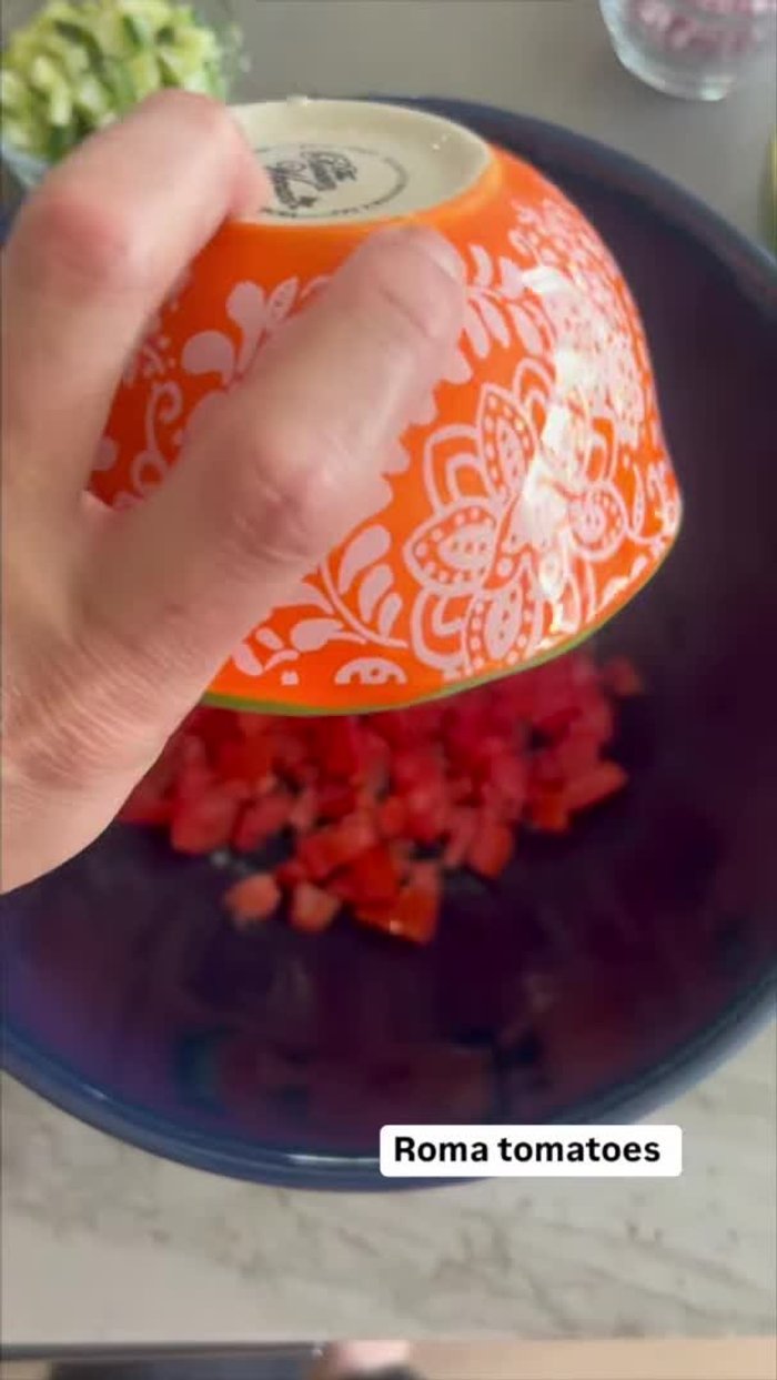 In a large mixing bowl, add diced Roma tomatoes, diced red onion, diced jalapeno, diced cucumber, and chopped cilantro.