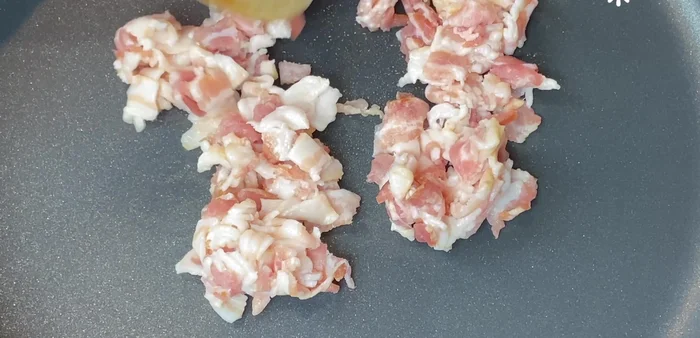 In a large skillet at medium heat, add bacon cut into small pieces and fry until completely golden.