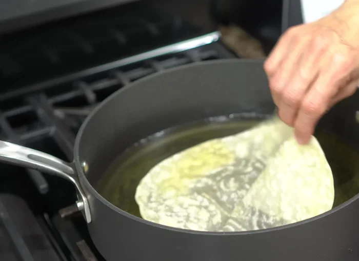 Fry the fritters in hot oil until golden brown (approximately 1 minute per side). Gently press the edges to release air bubbles while frying.