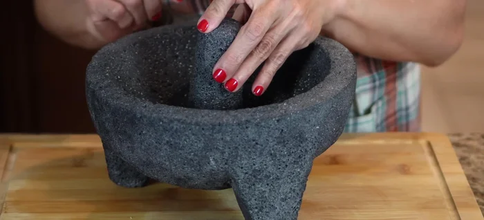 Make the seafood sauce: In a molcajete (or food processor/blender), crush roasted garlic, salt, and chiltepin peppers. Add red onion and crush until the juice releases.