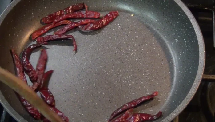Toast the Chile de Árbol until golden brown. Remove from heat.