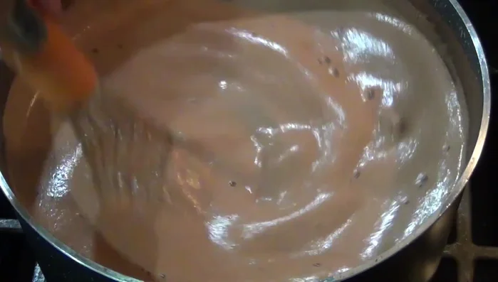 Stir in the dissolved cornstarch slurry, ensuring it mixes well and doesn't stick to the bottom of the pot. Continue stirring over medium heat.