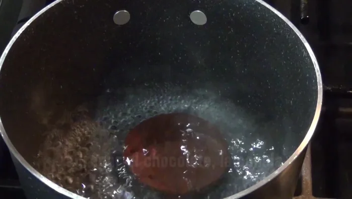 Bring 2 cups of water to a boil. Add the chocolate bars and cinnamon stick. Stir until the chocolate dissolves completely. This releases the aroma.