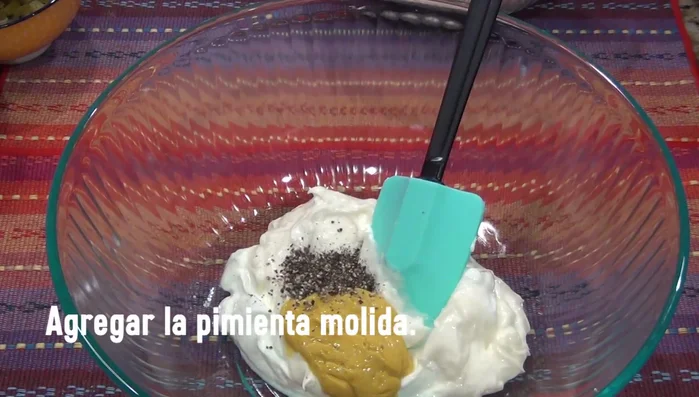 Add the chopped jalapeños, red onion, corn, and grated carrots to the cream mixture. Mix well.