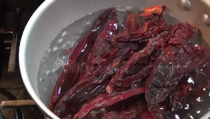 Boil guajillo, morita chiles, garlic, and onion in a separate pot until softened.
