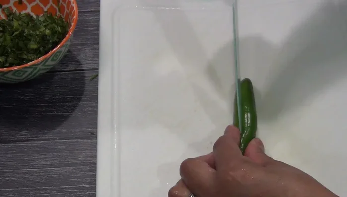 Peel and chop the serrano pepper.