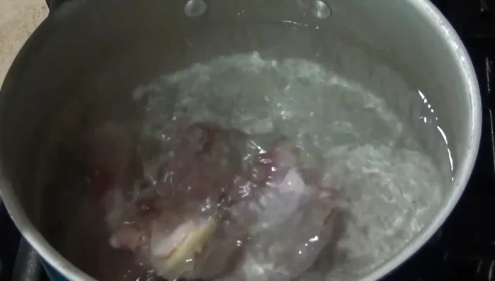 Prepare the chicken broth: In a pot, combine chicken pieces, 1/4 onion, 4 garlic cloves, salt, and enough water. Bring to a boil, then reduce heat and simmer until chicken is cooked. Remove chicken and set aside. Strain the broth and reserve.
