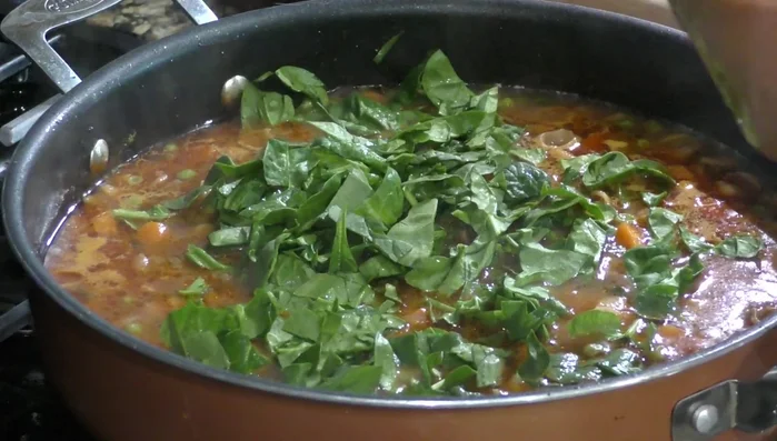 Add spinach and cilantro: Add spinach and chopped cilantro. Cook for a few more minutes.