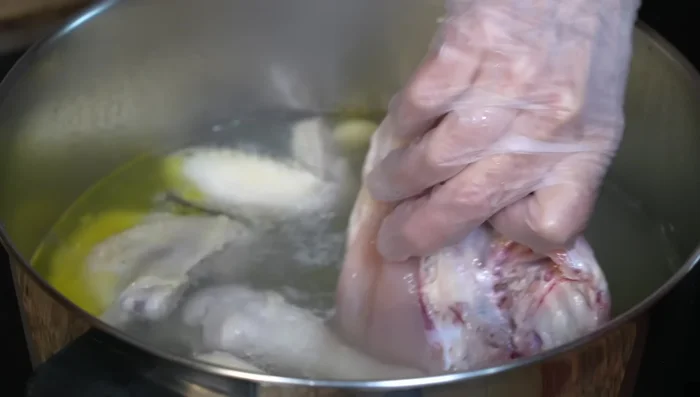 Add chicken breast (bone-in, skin-on). Simmer for 20 minutes, then remove from heat and let cool in the broth.