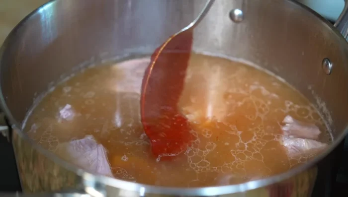 Stir in the prepared chili sauce (384.36) and continue cooking for an additional 1 hour 30 minutes over medium-low heat (403.919).