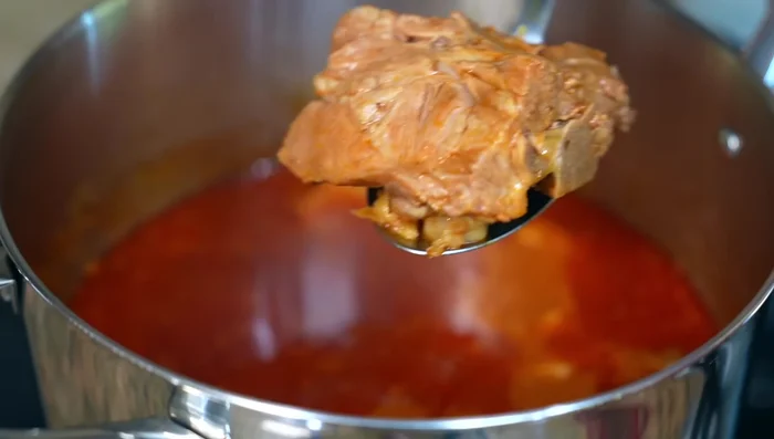 Remove the meat from the bones (421.62), shred it, and return it to the pot (427.819).