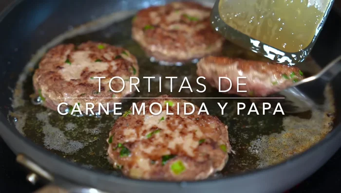Prepare potato pancakes: Boil potatoes until cooked (35 minutes). Mash potatoes partially. Mix with ground beef, grated onion, garlic, salt, pepper, paprika, mustard, green pepper, parsley, egg, and breadcrumbs.