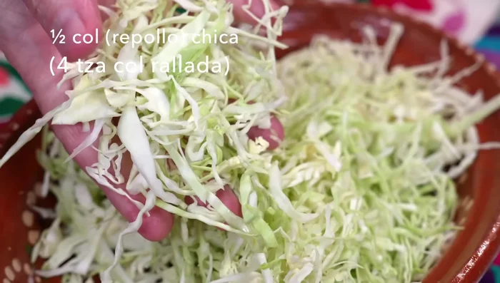 Make the carrot cabbage salad: Thinly slice cabbage, grate carrots, and chop scallions. Mix with mayonnaise, yogurt, mustard, vinegar, sugar, salt, and pepper. Let rest to soften.