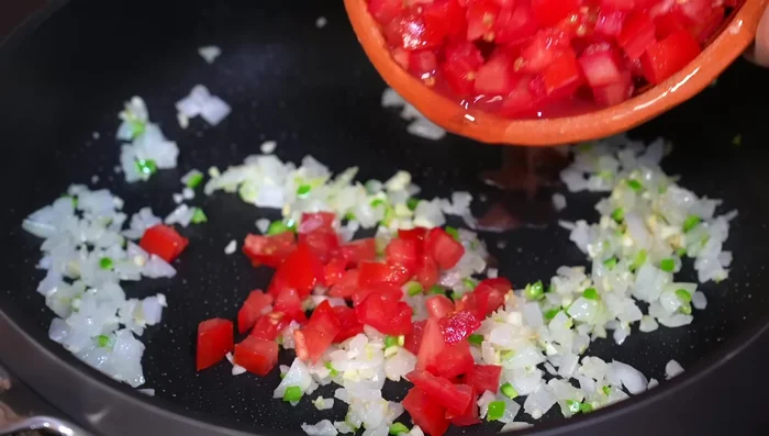 Add the chopped tomatoes and salt, cooking until they release their juices (about 5 minutes).