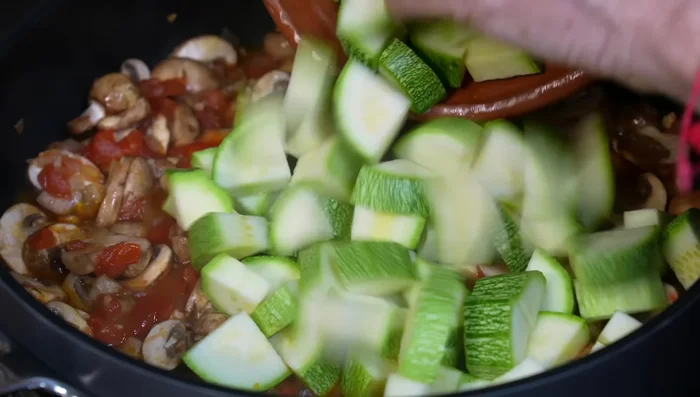 Add the zucchini, season with salt, stir, lower the heat, and cover the pan for 10 minutes.