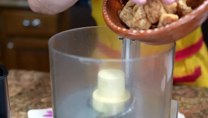 Process pork rinds into small pieces using a blender or food processor. You can also chop them finely with a knife.