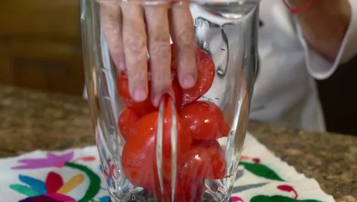 Blend tomatoes, onion, garlic, water, and chipotle peppers until smooth.