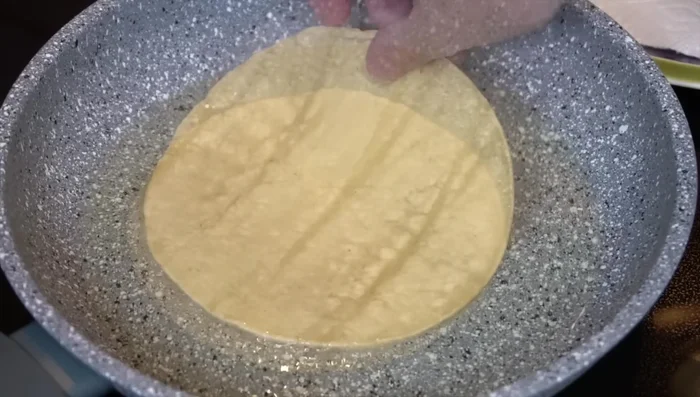 Lightly fry corn tortillas in hot oil until pliable. Drain on paper towels.