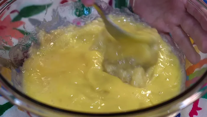 Combine wet ingredients: Add beaten eggs to mashed plantains. If plantains aren't ripe enough, let sit for 20-30 minutes. Then, add white sugar, brown sugar, oil, butter, vanilla extract, and buttermilk. Mix until sugar dissolves.