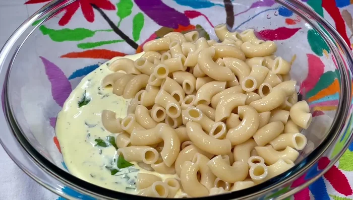 Combine the cooled macaroni, drained onion, cucumber, red pepper, celery, and tuna with the dressing. Mix gently.