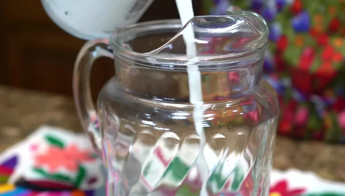 In a pitcher, combine the cinnamon water, remaining water, milk, condensed milk, evaporated milk, vanilla, and ice. Stir well.