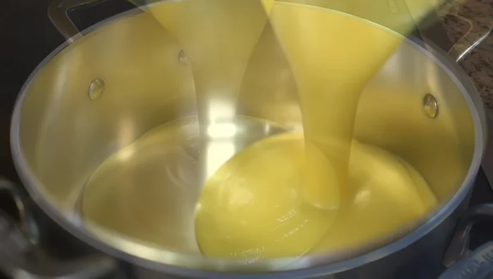 In the same pot, gently heat the blended plantain mixture over medium-low heat.