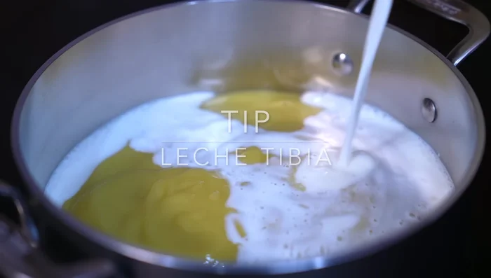 Once warm, gradually incorporate warm milk into the mixture, stirring constantly to prevent curdling.