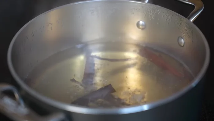 Once fragrant, add plantains to the boiling water. Cover and simmer for 15 minutes.