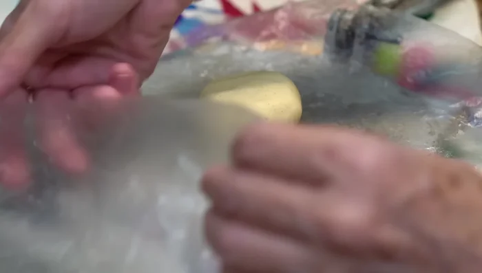 Assemble the empanadas: Place a dough ball between two sheets of plastic and press using a tortilla press. Fill with the cooled shrimp filling, seal the edges tightly using the plastic, ensuring they won't open while frying.