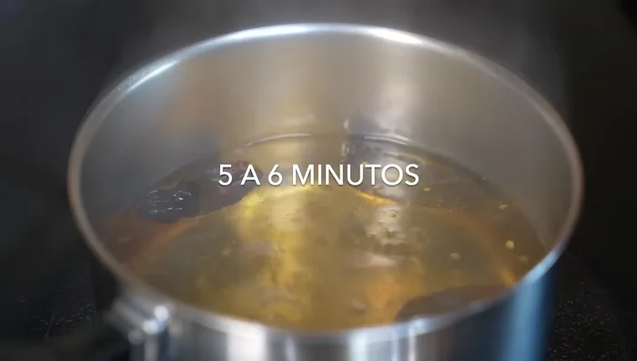 Add tomatoes (stems removed) to the pot and cook until skins burst. Turn off heat and let cool.