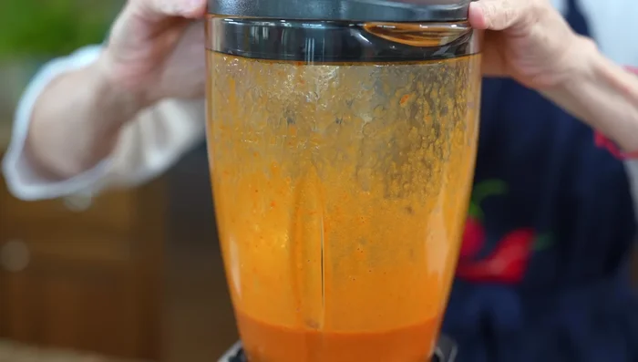 Add the blended mixture to the cooled tomatoes and blend again.