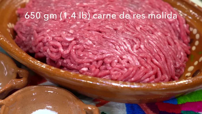 Season ground beef with salt, pepper, and finely chopped garlic.