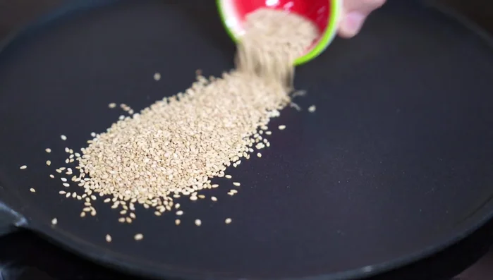 Prepare the marinade: Combine toasted sesame seeds, sesame oil, low-sodium soy sauce, salt, pepper, garlic, chipotle adobo, achiote, and apple cider vinegar. Mix well.