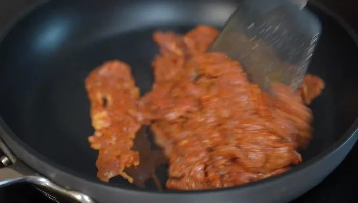 Cook the marinated pork in a hot pan, stirring constantly until cooked through (a few minutes).