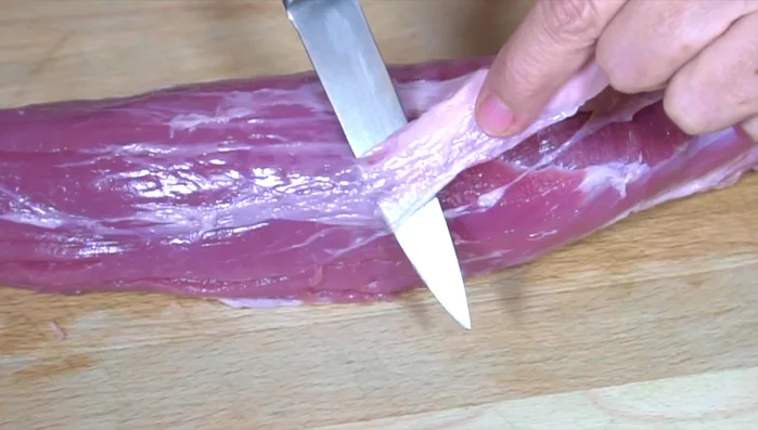 Remove the membrane from the pork loin steak using a sharp knife. (This makes it super tender)