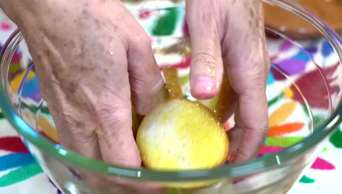Bake bread at 350°F (180°C) until golden brown, flipping halfway through. Once golden, add to the container and sprinkle with Parmesan cheese.