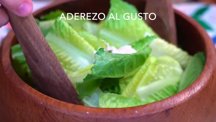 Add the dressing to the lettuce, mixing to coat evenly.