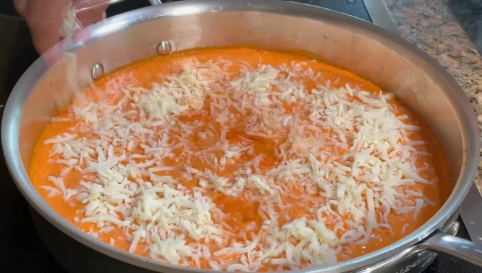 Add more cheese and cover to melt. Simmer until the cheese is melted (4-5 minutes).