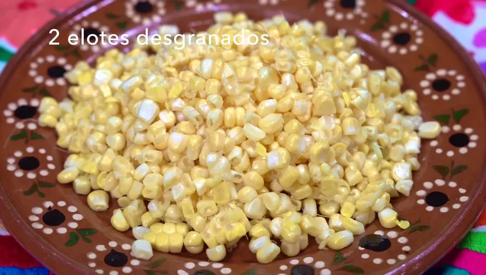 Shell corn cobs and chop onion.