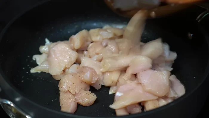 Cook the chicken in hot oil until sealed, then add the sauce and heat through.