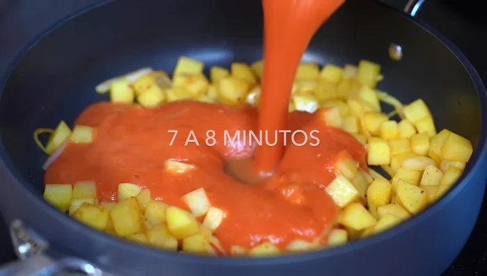 Pour the blended tomato sauce into the pan. Add bay leaves, salt or chicken broth powder to taste.
