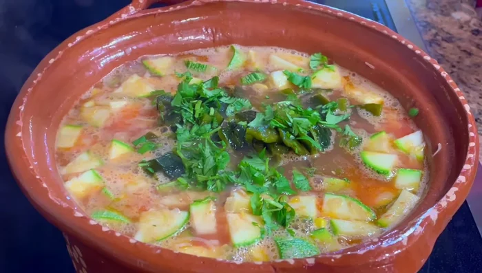 Add diced poblano peppers, cilantro or epazote, and chochoyotes. Cook until zucchini and chochoyotes are tender, and flavors have melded (another 10-15 minutes).