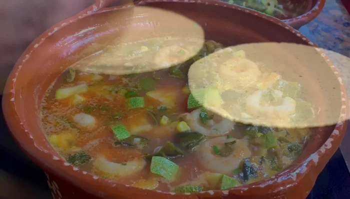 Serve hot with warm corn tortillas, panela cheese, and pork rinds (optional).
