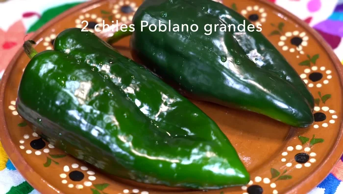 Roast, peel, clean, and cut two large (or three small) poblano peppers into strips.