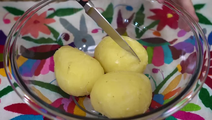 Once potatoes are cool, peel and mash them thoroughly. Let them cool before mashing.