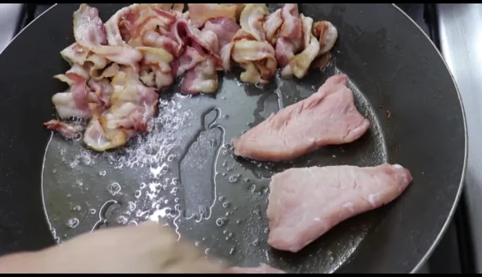 In a wide pan, sear the pork chops in the reserved bacon grease until partially cooked.